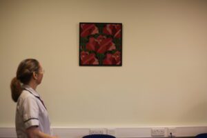 Therapy services manager admiring tapestry